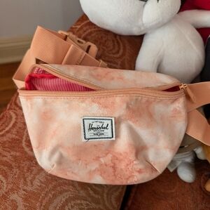 Herschel Supply Co. fanny pack in tie dyed pastel cloud pink papaya. One zipper.